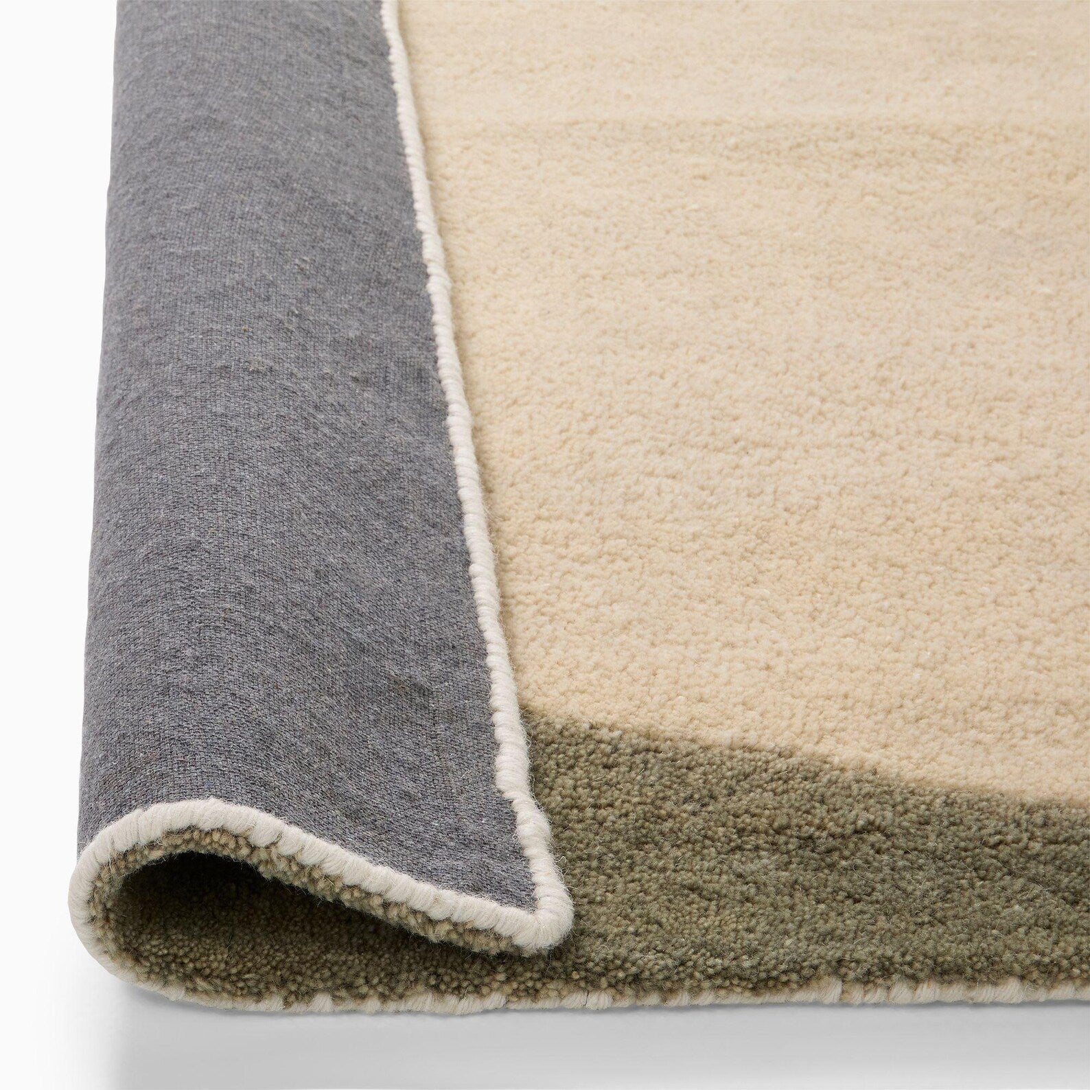 Minimal Solara rug Folded edge view of Solara Rug highlighting durable wool backing and fine tufting.